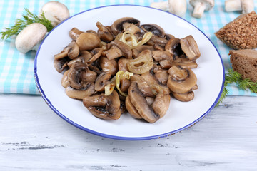 Delicious fried mushrooms on plate on table close-up