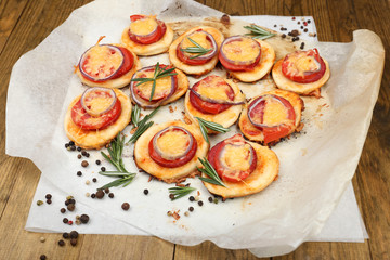 Small pizzas on baking paper close up