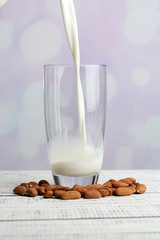 Almond milk is poured into glass,