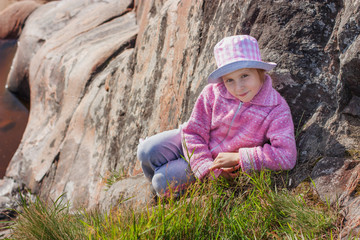 Happy girl on a rock.