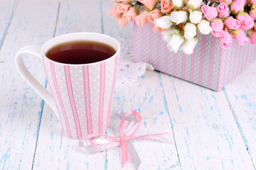 Fragrant tea with flowers on wooden table close-up