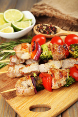 Pork kebab on wooden table close up
