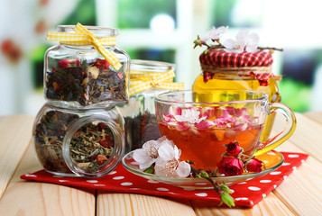 Assortment of herbs, honey and tea in glass jars