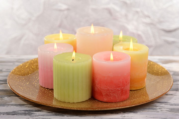 Beautiful candles on table on grey background