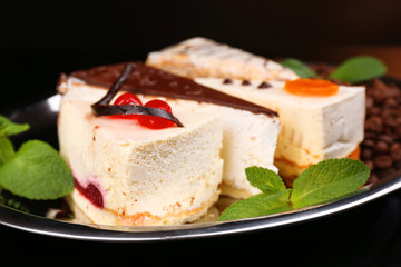 Assortment of pieces of cake, on dark background © Africa Studio