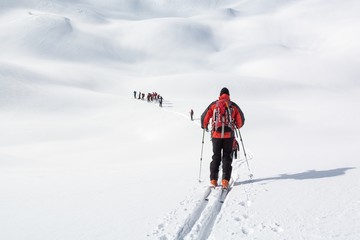 Fototapeta na wymiar Skiers walking over snowy planes