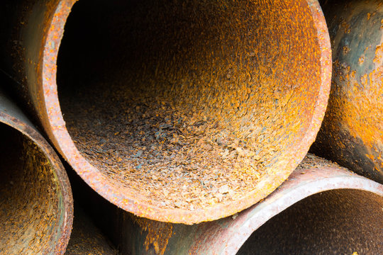 Part of rusty old pipes stacked up with natural light