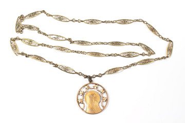 Antique necklace with Virgin Mary pendant isolated on white