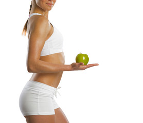 young attractive sporty woman with green apple