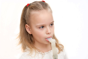 young girl using inhaler