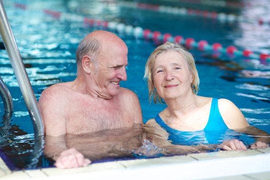 Happy couple of seniors enjoying in swimming pool