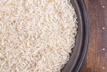 Plate of Rice on Dark Wood Background