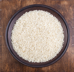 Plate of Rice on Dark Wood Background