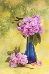 Sakura flowers in a blue vase.
