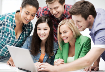 students looking at tablet pc in lecture at school