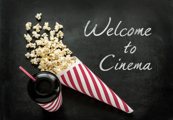 Welcome to cinema poster with drink and popcorn