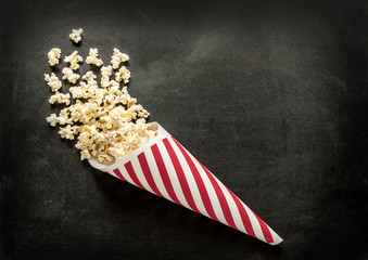 Cornet popcorn on black chalkboard - cinema snack