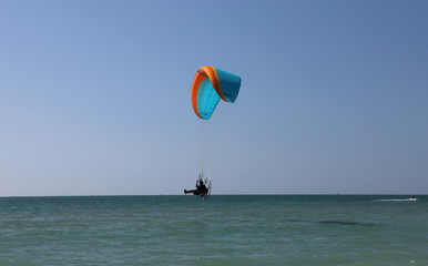 paraglider over ocean