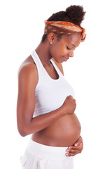 Young pregnant black woman touching her belly - African people