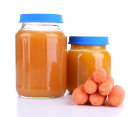 Baby food with carrot in glass jars, isolated on white