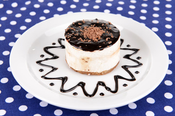 Sweet cake with chocolate on plate on table close-up
