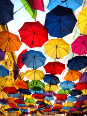Fototapeta na wymiar A lot of multicolored umbrellas over the sky