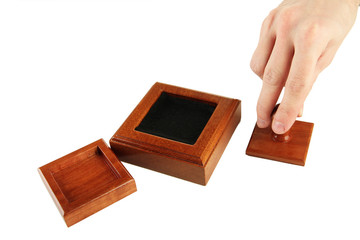 Hand holding wooden stamp isolated on white