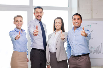 business team showing thumbs up in office