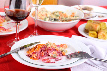 Table with festive dishes after feast close-up