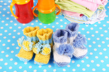 Composition with crocheted booties for baby, clothes and other