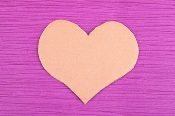 Paper heart on purple background