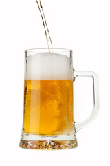 Pouring a pint of sparkling beer isolated on white background