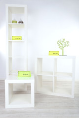 New white shelves with prices on light background