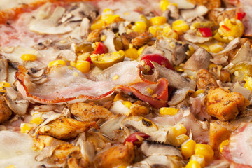 Fresh tasty pizza close up with sausage, corn, pepper and cheese