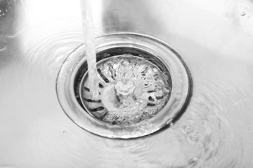 Water flowing down hole in kitchen sink