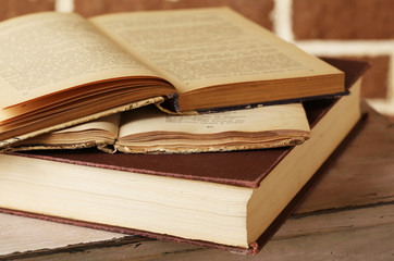 Books on wooden ladder on  color wall background