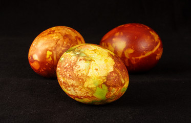 Three traditional painted Easter eggs on the dark background