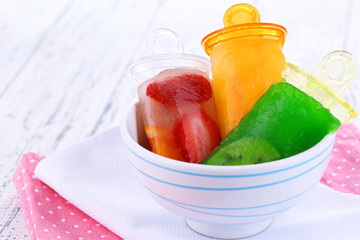 Fruit ice cream in bowl on wooden table close-up