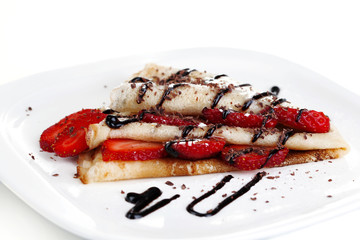 Delicious pancake with strawberries and chocolate