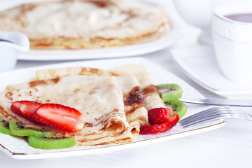 Delicious pancakes with strawberries and chocolate