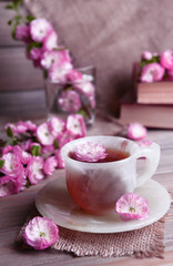 Fototapeta na wymiar Beautiful fruit blossom with cup of tea