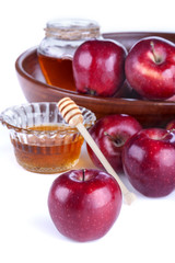 apples in a bowl with honey on a white background