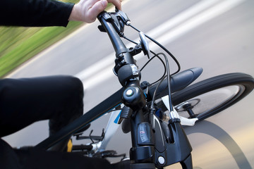 Man riding modern bicycle, handlebar top view rig shot in motion - Powered by Adobe