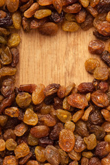 Diet healthy food. Border of raisin on wooden background