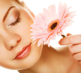Beautiful young woman with gerber flower