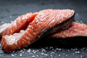 Fresh raw salmon on a black rock