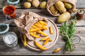 Fresh homemade fries with salt and ketchup
