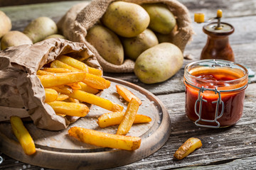 Closeup of homemade fries with ketchup and salt