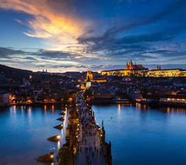 Naklejka premium Night view of Prague castle and Charles Bridge over Vltava river