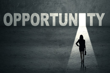 Businesswoman in front of opportunity door